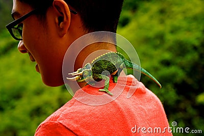 Boy with chameleon horned lizard in jungle Editorial Stock Photo